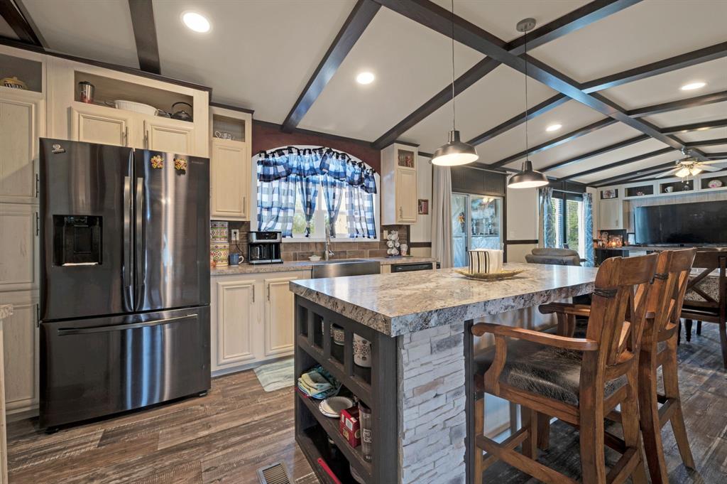 12032 County Road 0190 Rice, TX 75155 - Photo 20 of 40 a kitchen with stainless steel appliances granite countertop a table chairs refrigerator and sink