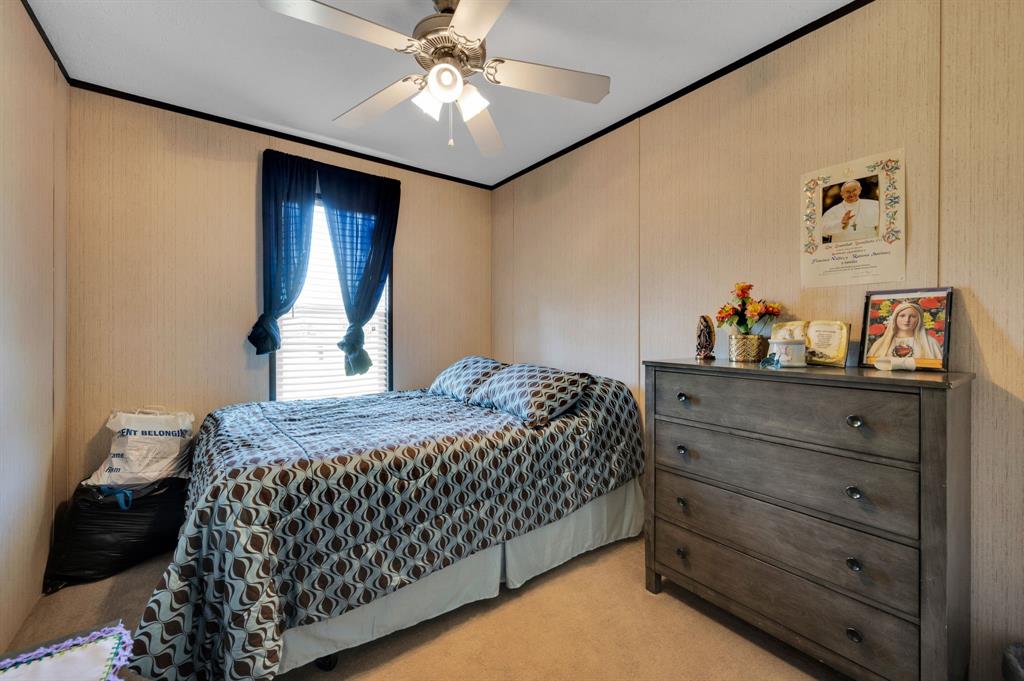 12032 County Road 0190 Rice, TX 75155 - Photo 27 of 40 a bedroom with a bed and a chandelier
