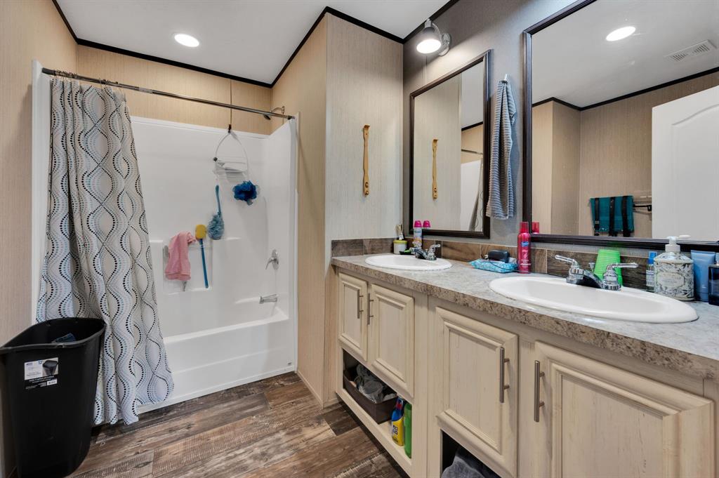 12032 County Road 0190 Rice, TX 75155 - Photo 28 of 40 a spacious bathroom with a granite countertop sink a mirror a shower and a bathtub