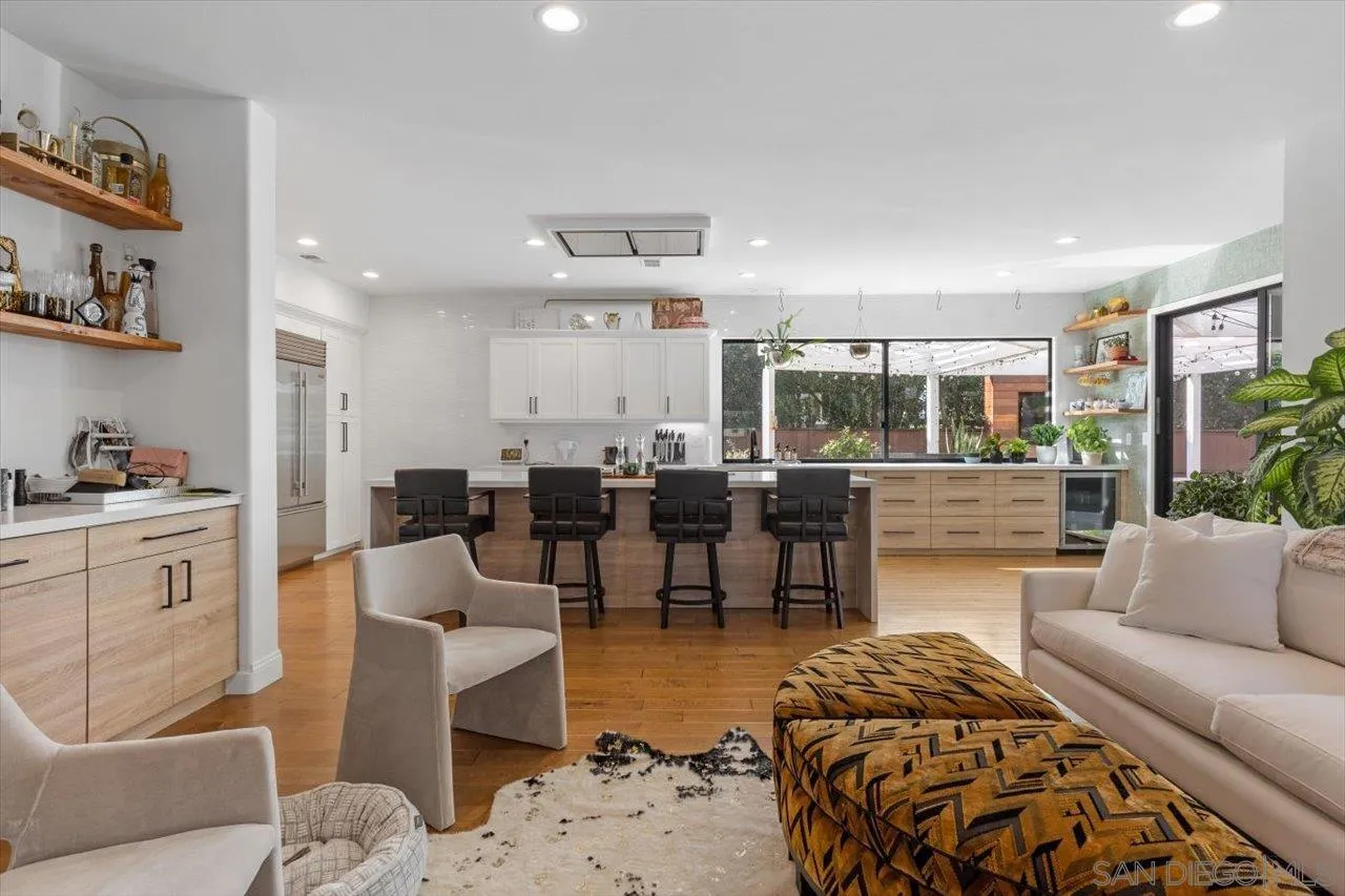 219 Jacob Lane Encinitas, CA 92024 - Photo 12 of 46 a living room with furniture a rug kitchen view and a table