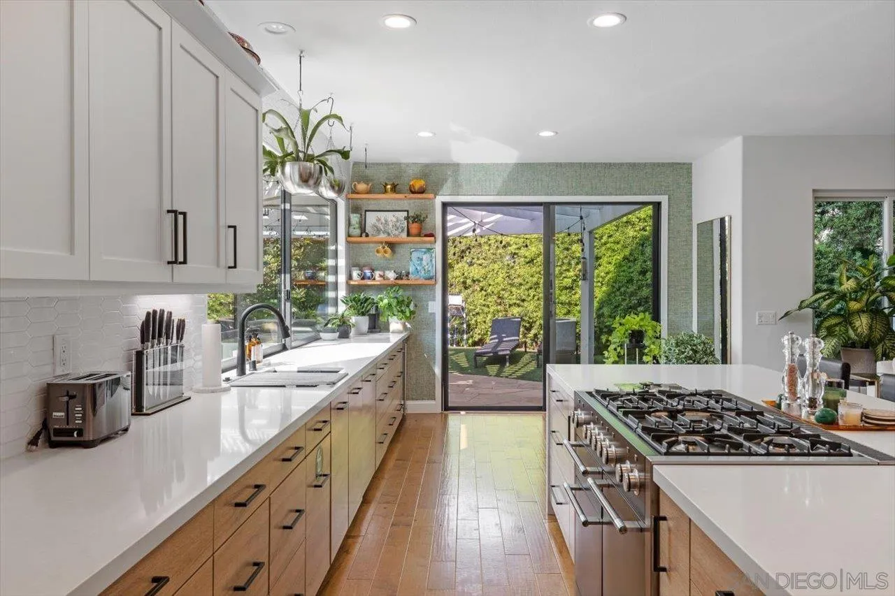 219 Jacob Lane Encinitas, CA 92024 - Photo 14 of 46 a kitchen with stainless steel appliances a sink stove and cabinets
