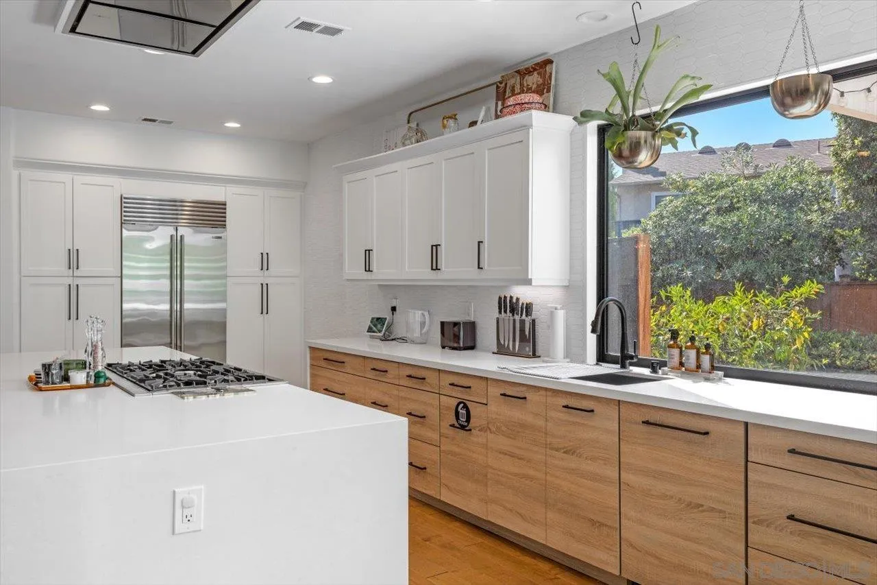219 Jacob Lane Encinitas, CA 92024 - Photo 16 of 46 a kitchen with a stove a sink and a refrigerator