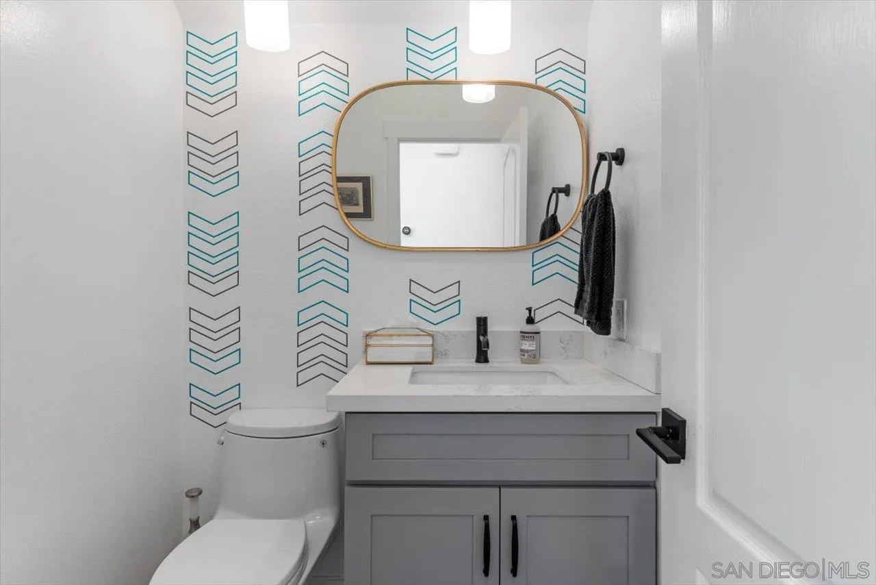 219 Jacob Lane Encinitas, CA 92024 - Photo 18 of 46 a bathroom with a sink a toilet and a mirror