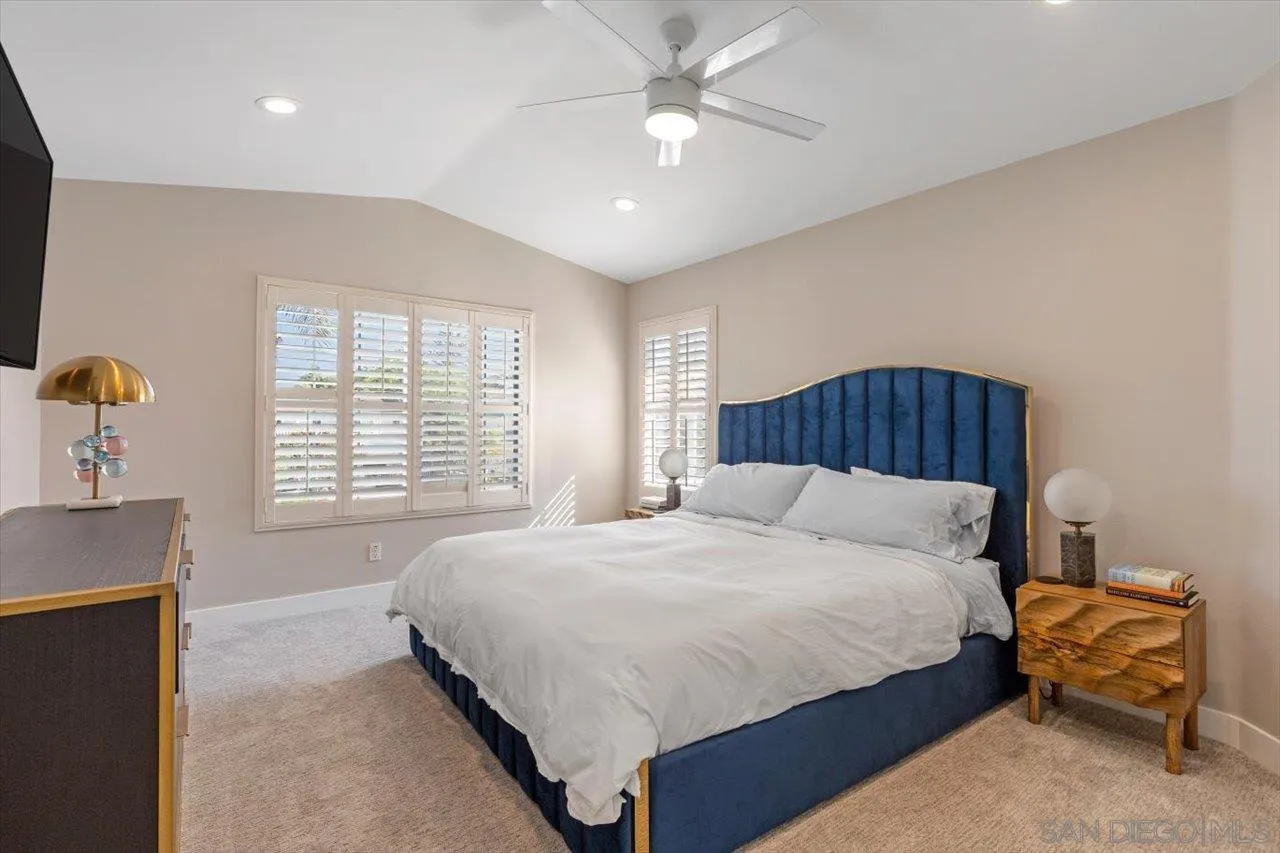 219 Jacob Lane Encinitas, CA 92024 - Photo 19 of 46 a bedroom with a large bed and a chandelier
