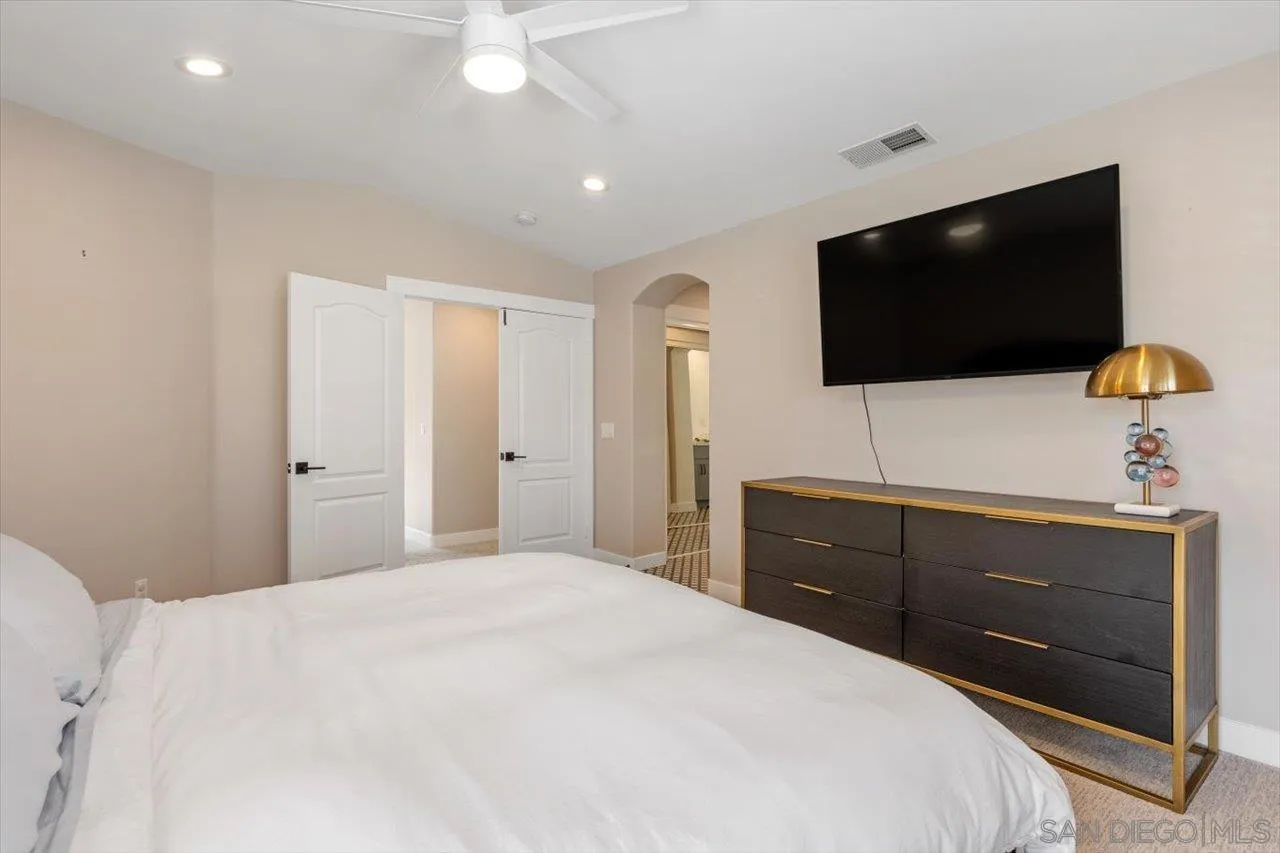 219 Jacob Lane Encinitas, CA 92024 - Photo 20 of 46 a bedroom with a bed and a flat screen tv