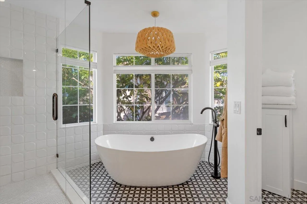 219 Jacob Lane Encinitas, CA 92024 - Photo 23 of 46 a bathroom with a bathtub and a shower