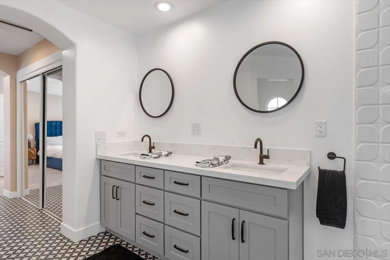 219 Jacob Lane Encinitas, CA 92024 - Photo 24 of 46 a bathroom with a double vanity sink and a mirror