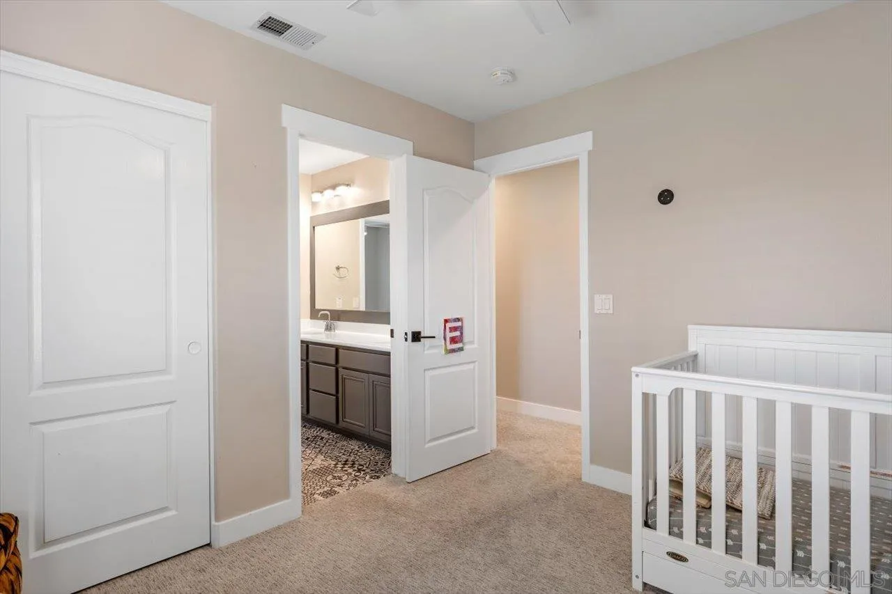 219 Jacob Lane Encinitas, CA 92024 - Photo 26 of 46 a room with a wooden floor and white doors