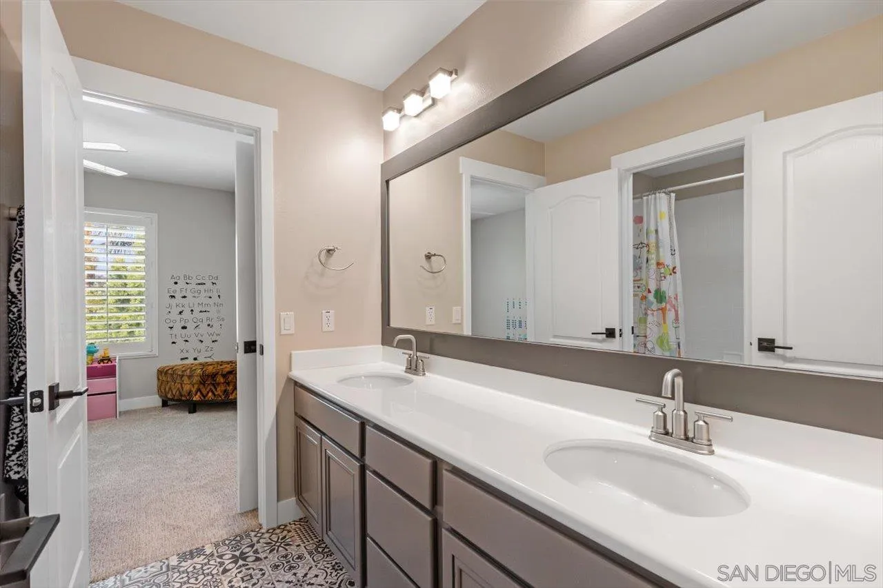 219 Jacob Lane Encinitas, CA 92024 - Photo 27 of 46 a en suite bathroom with a double vanity sink double and mirror
