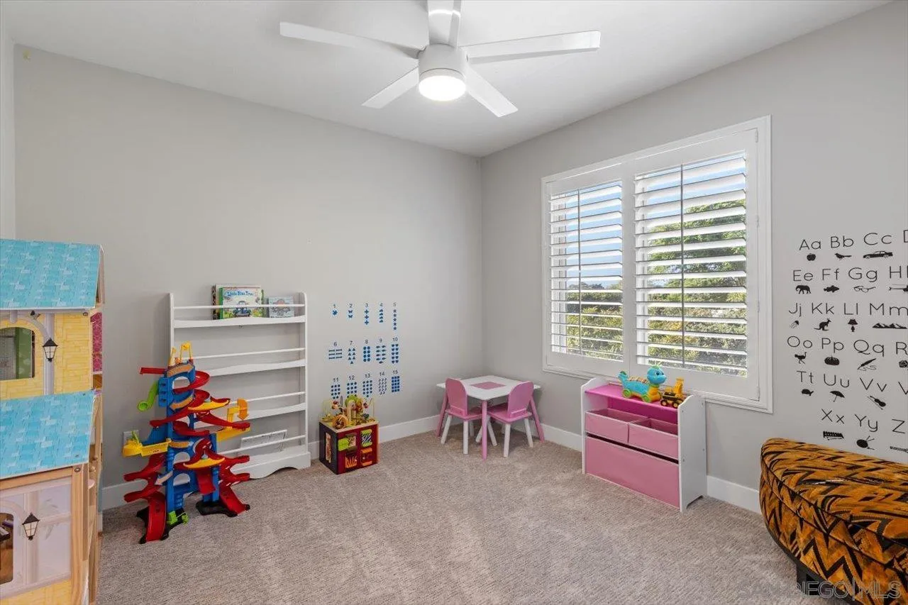 219 Jacob Lane Encinitas, CA 92024 - Photo 28 of 46 a children room with furniture and a chandelier
