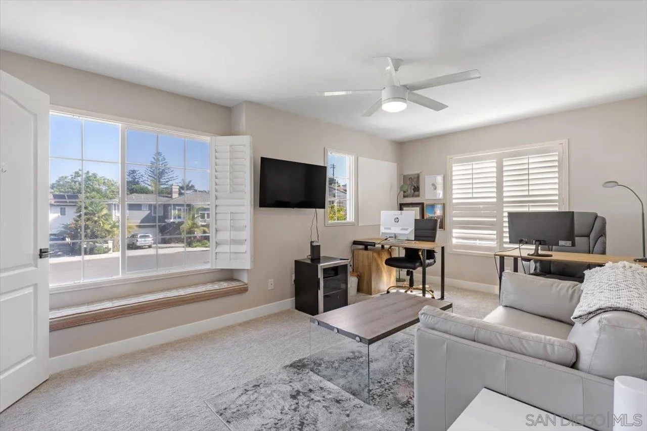 219 Jacob Lane Encinitas, CA 92024 - Photo 31 of 46 a living room with furniture a flat screen tv and a large window