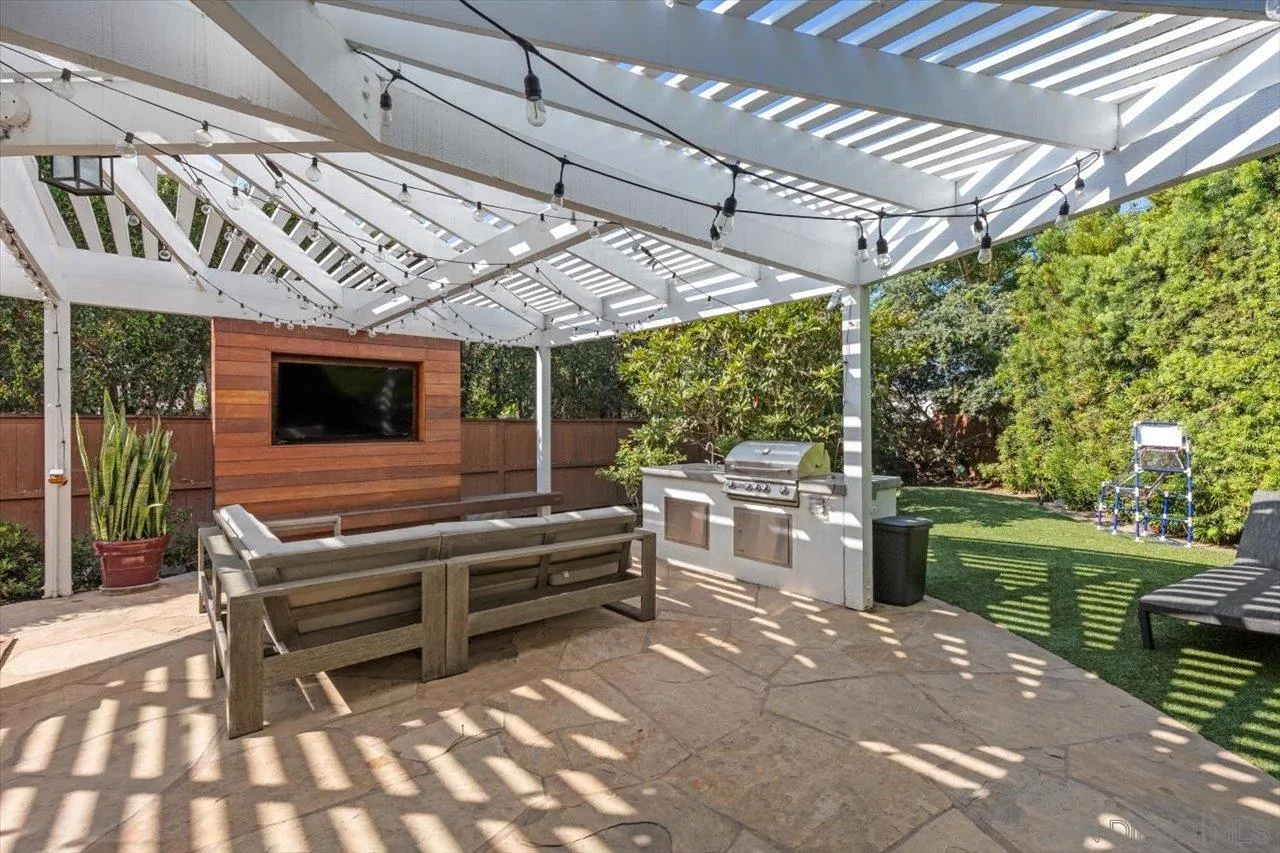 219 Jacob Lane Encinitas, CA 92024 - Photo 34 of 46 a view of a patio with a table chairs and a yard