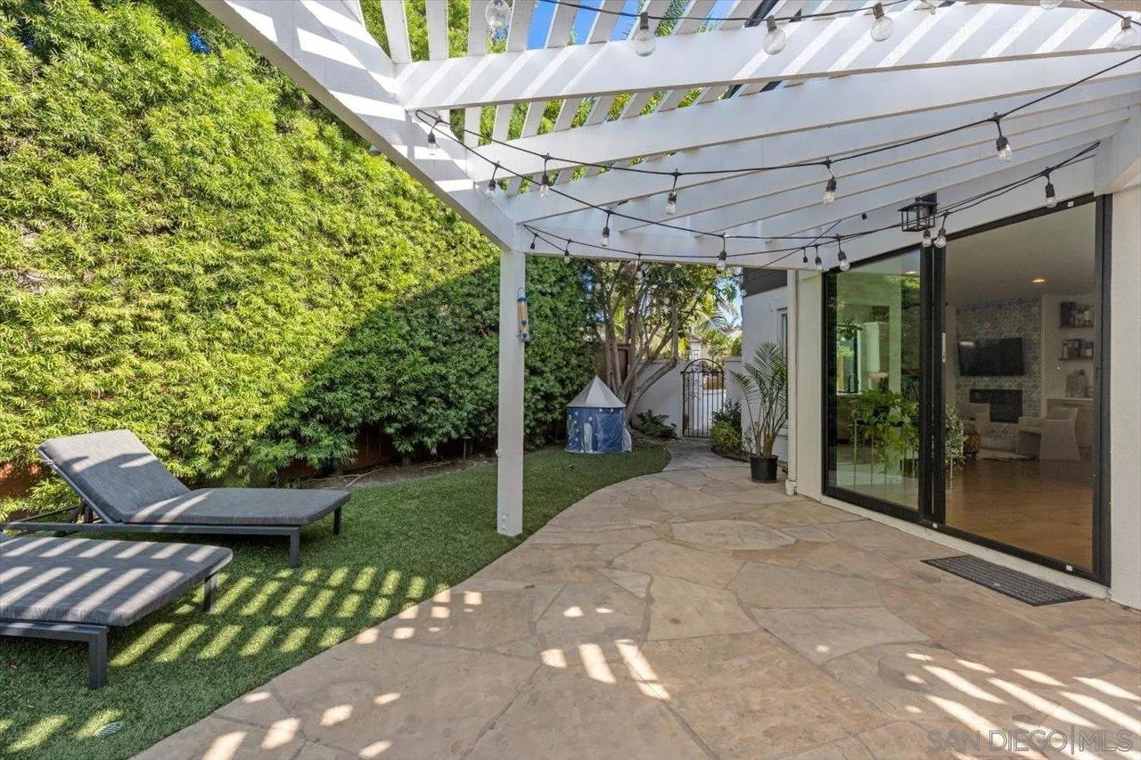 219 Jacob Lane Encinitas, CA 92024 - Photo 40 of 46 a view of a patio with a table chairs and a backyard