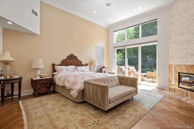 a spacious bedroom with a bed a table and a large window