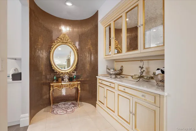 a bathroom with a granite countertop toilet a sink and a mirror