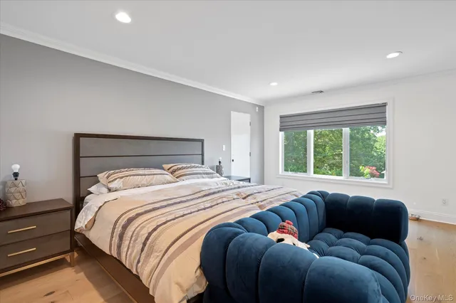 a bed sitting in a bedroom next to a window