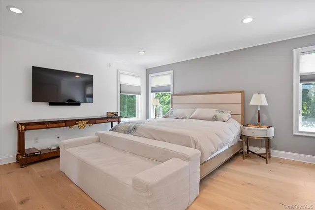 a bedroom with bed and a flat screen tv