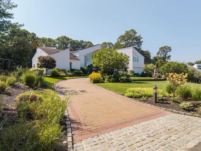 a view of a house with a garden and pathway