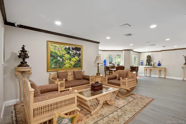 a living room with furniture a window and a flat screen tv