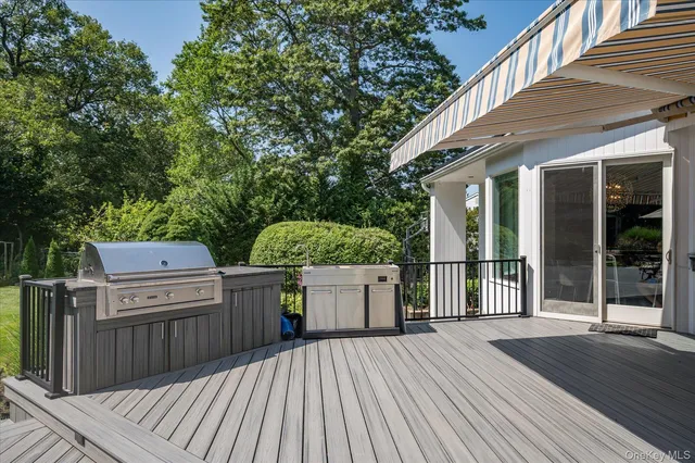 a view of a wooden deck and a backyard