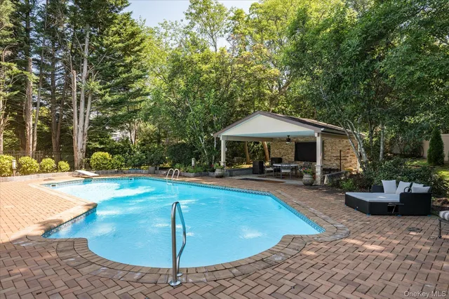 a view of a house with swimming pool and sitting area