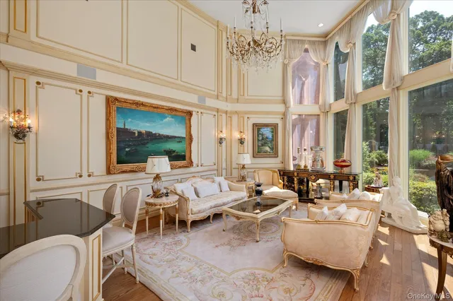 a living room with furniture a chandelier and a fireplace