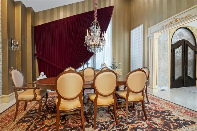 a view of a dining room with furniture chandelier and wooden floor