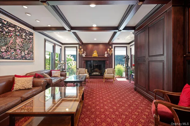 a living room with furniture a fireplace and a chandelier