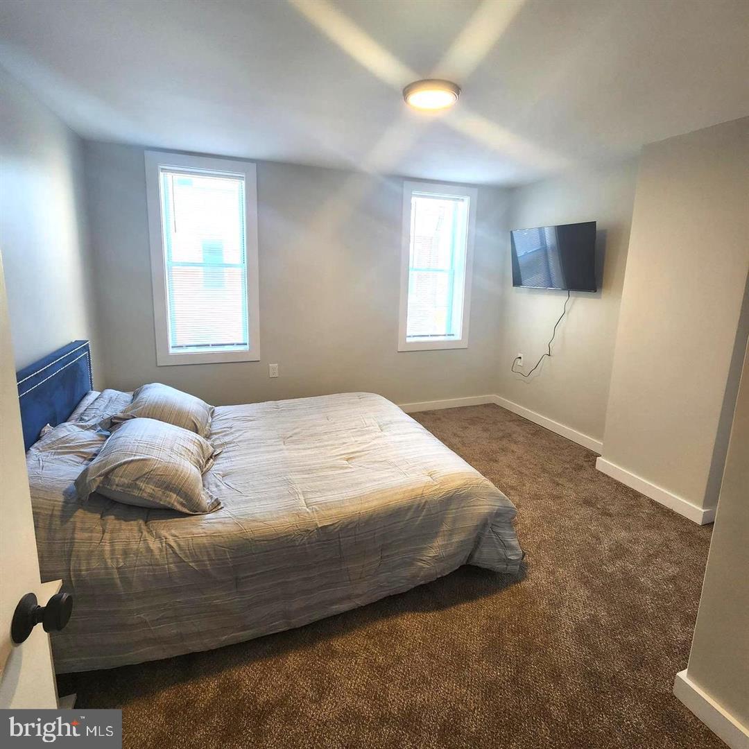 1247 South Newkirk Street Philadelphia, PA 19146 - Photo 13 of 20 a bedroom with a bed window and a flat screen tv