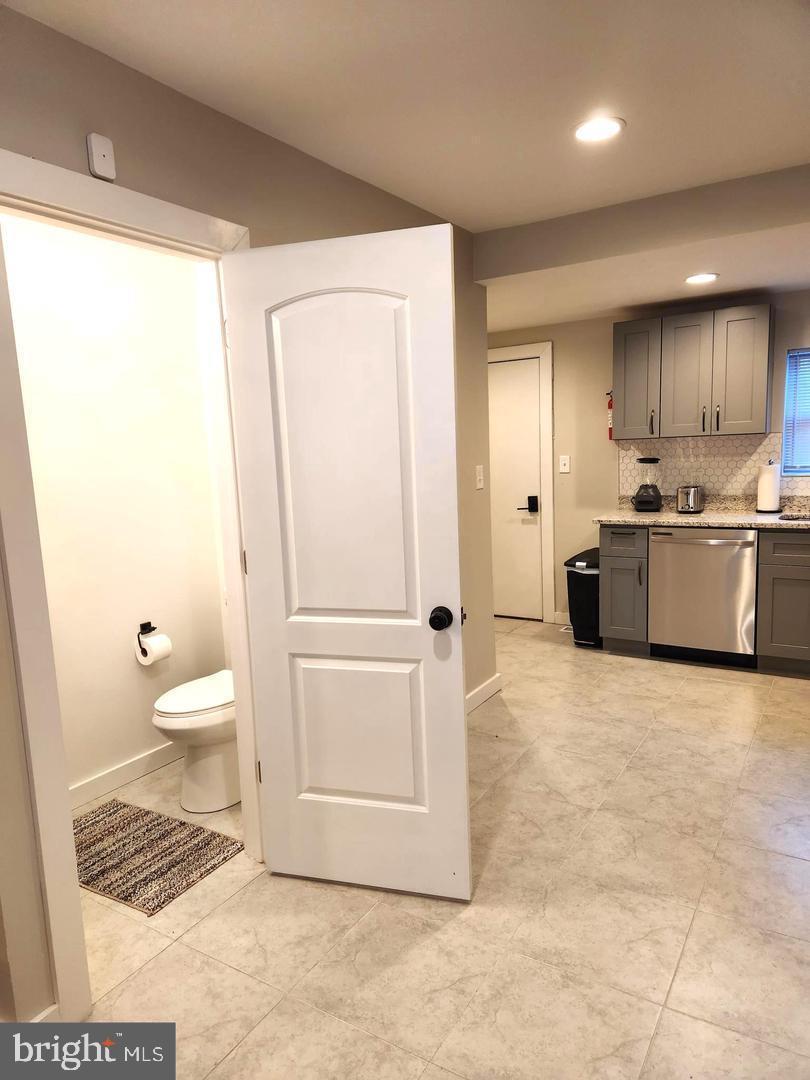 1247 South Newkirk Street Philadelphia, PA 19146 - Photo 10 of 20 a kitchen with stainless steel appliances a refrigerator and a stove top oven
