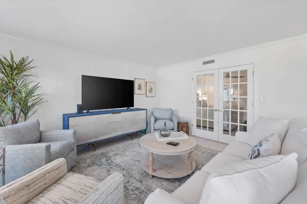 a kitchen with granite countertop cabinets a stove a dining table and chairs with wooden floor