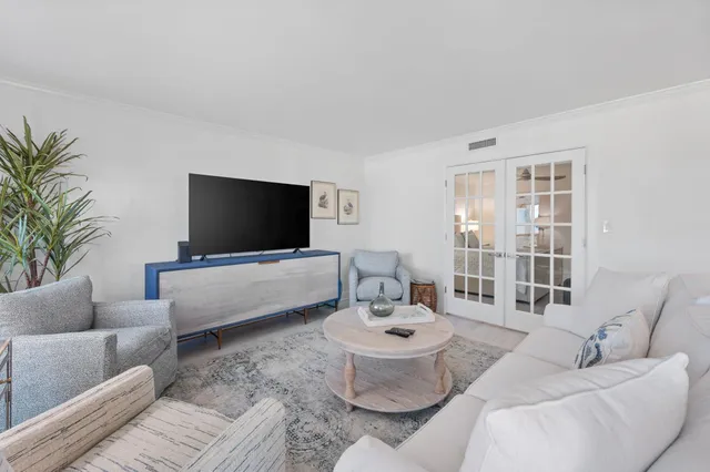 a kitchen with granite countertop cabinets a stove a dining table and chairs with wooden floor