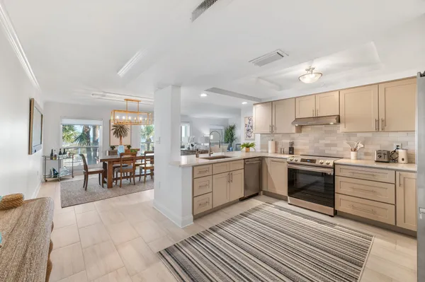 a kitchen with granite countertop white cabinets stainless steel appliances and sink