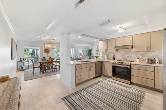 a kitchen with granite countertop white cabinets stainless steel appliances and sink