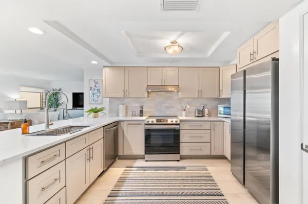 a kitchen with a table chairs sink and cabinets