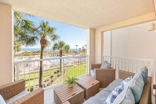 a dining room with furniture a rug and wooden floor