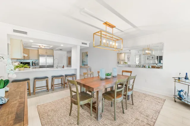 a view of a dining room with furniture and a kitchen