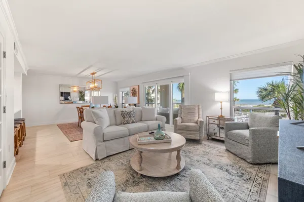 a living room with furniture a flat screen tv and a large window