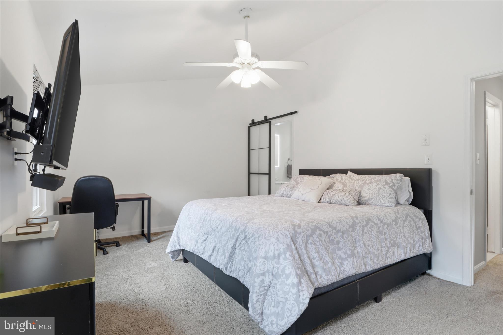 71 Kinsman View Circle Silver Spring, MD 20901 - Photo 17 of 42 a bedroom with a bed tv and a mirror