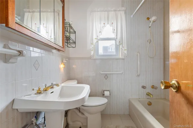 a bathroom with a sink a toilet and a bathtub