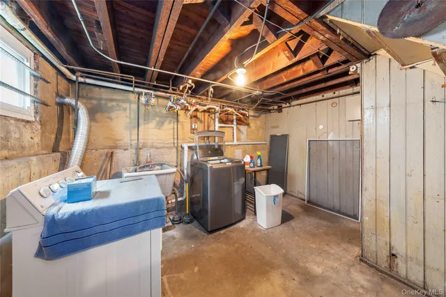 a view of walk in closet with window and chandelier