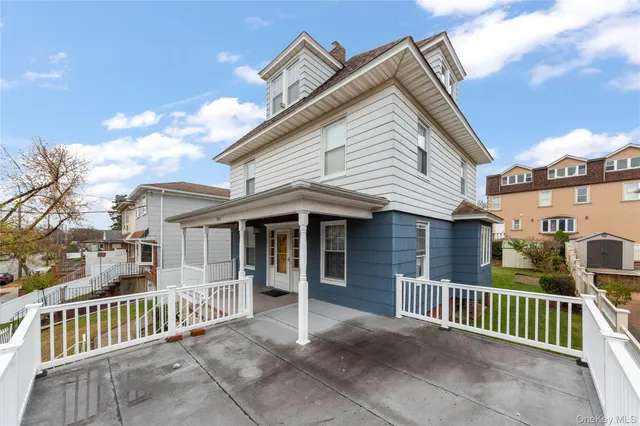 a view of a house with a wooden fence