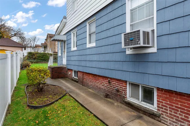a view of a backyard with chairs and a potted plant