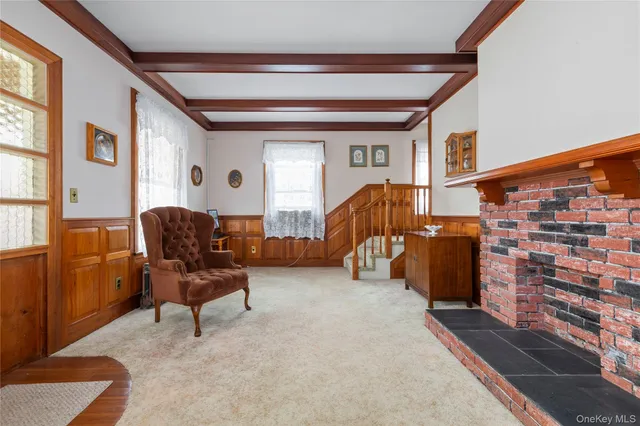 a living room with furniture a window and a lamp