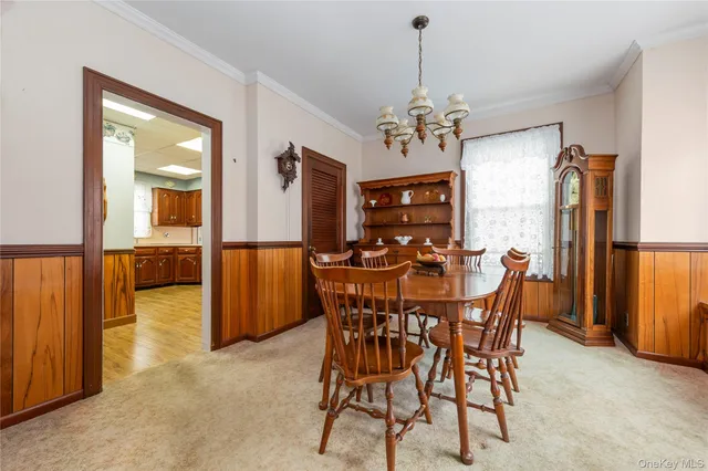 a view of a dining room with furniture and a chandelier