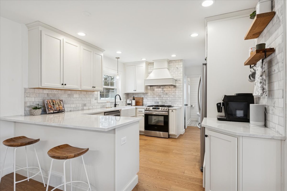 736 Ottawa Avenue Park Ridge, IL 60068 - Photo 7 of 33 a kitchen with stainless steel appliances granite countertop a stove top oven a sink a dining table and chairs with wooden floor