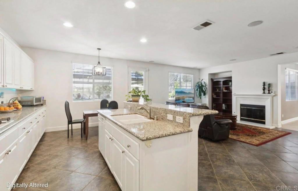 1234 Old Janal Ranch Road Chula Vista, CA 91915 - Photo 18 of 34 a large kitchen with sink a stove and cabinets