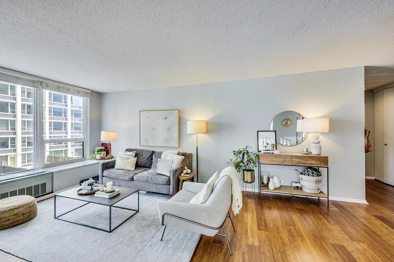 1313 North Ritchie Court, Unit 505 Chicago, IL 60610 - Photo 5 of 27 a living room with furniture and a large window