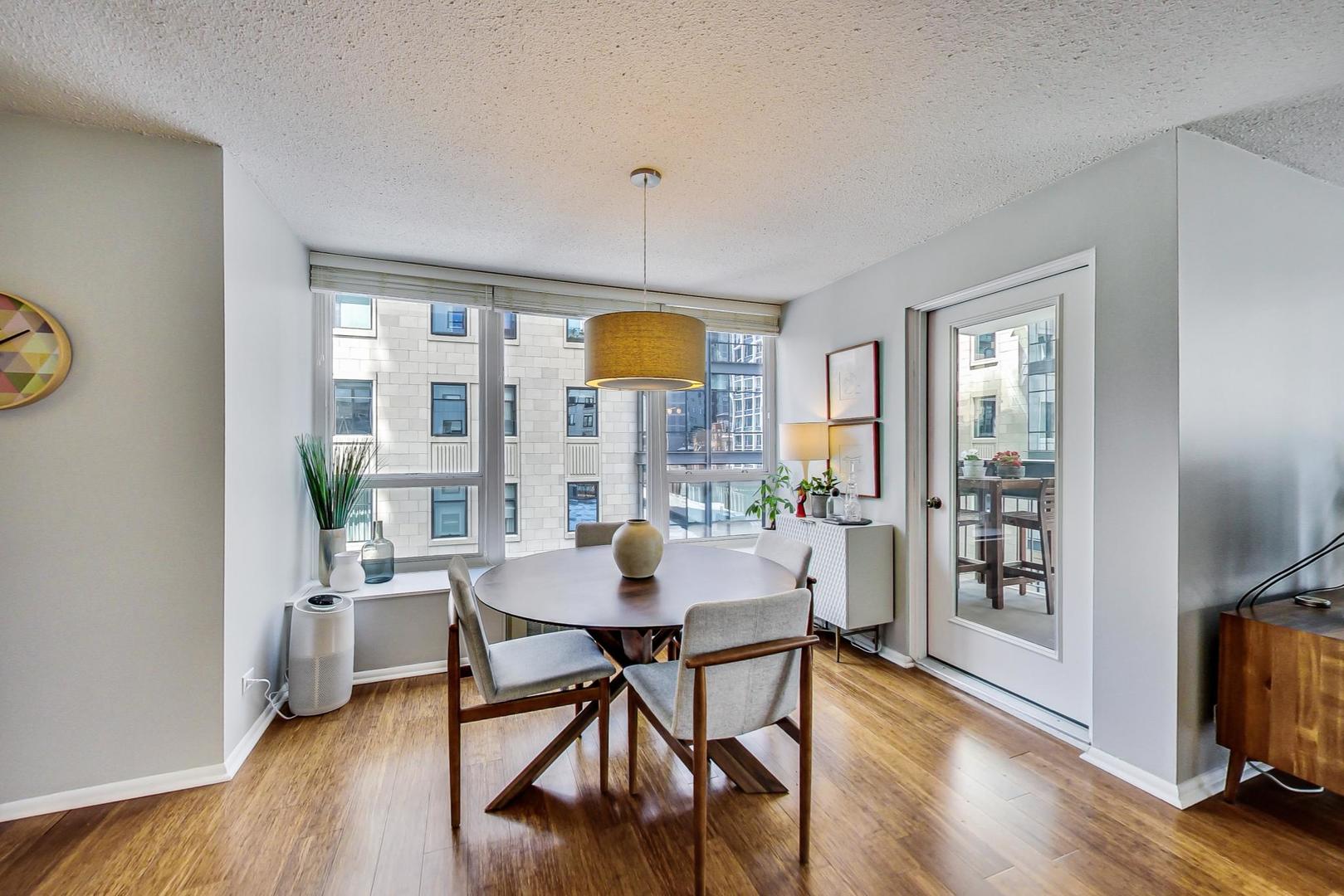 1313 North Ritchie Court, Unit 505 Chicago, IL 60610 - Photo 6 of 27 a view of a dining room with furniture window and wooden floor