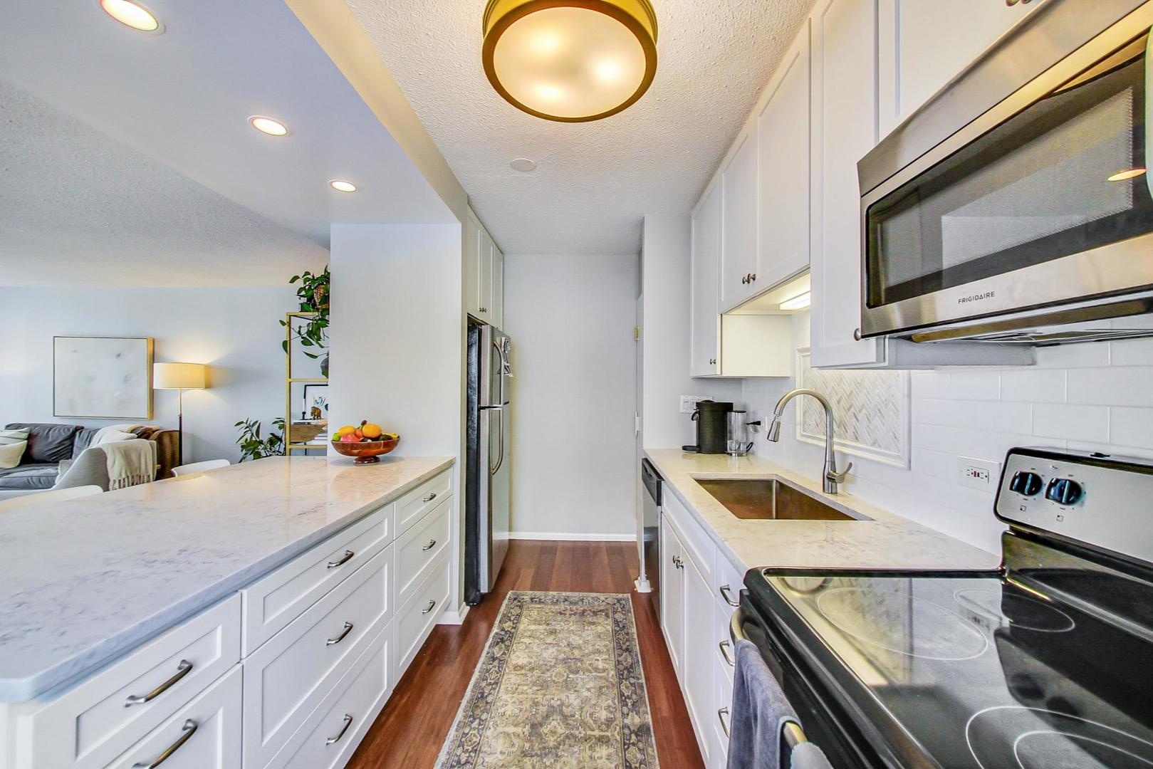 1313 North Ritchie Court, Unit 505 Chicago, IL 60610 - Photo 9 of 27 a kitchen with a sink and a stove